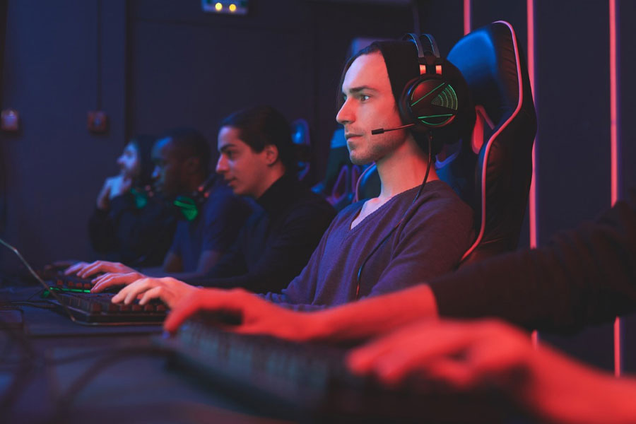 an esports player with his teammates competing. entering esports as a competitor is a great way for gamers earn money