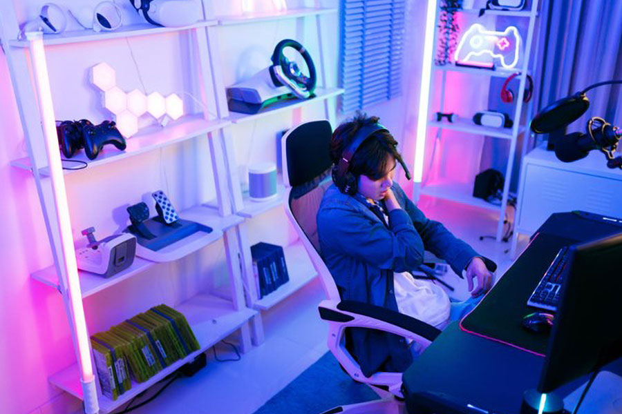 a gaming room with a limited size equipped by pc setup, posters, lights, tv, action figure and poster. even at a small size you can use gaming room ideas for small rooms.