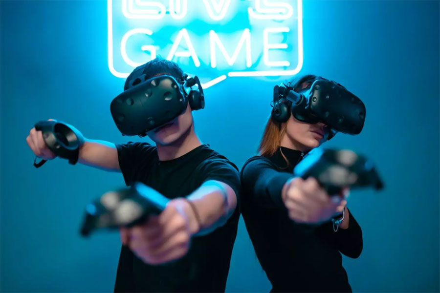 two gamers using VR Headset to play games to find aaa meaning in games.