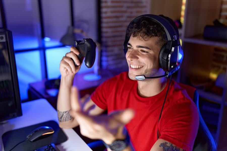 Picture of a Gamer in front of his setup, Many factors affect how many gamers are there in the world.