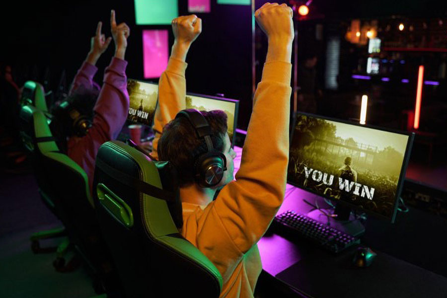 Gamers celebrating their win at a tournament.