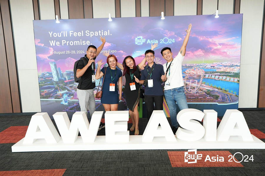 five persons taking picture due to sponsorship for AWE Asia 2025.