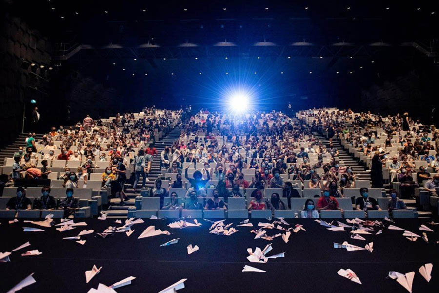 a hall full of people sitting on chairs in Annecy Festival 2025.