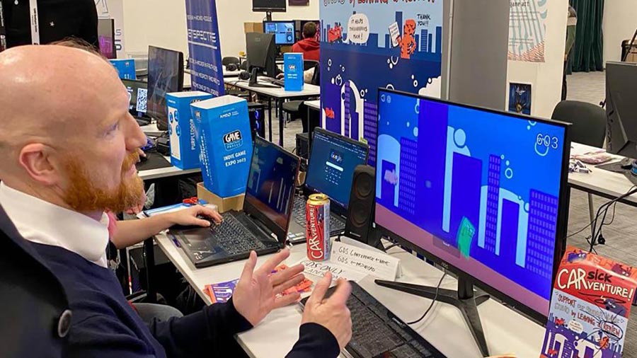 a man playing in front of computer screen in Game Developers Session Prague 2025