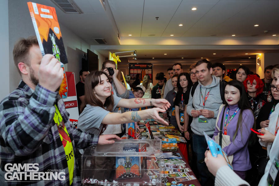 a guy introducing a magazine about video games in front of people in Games Gathering Kyiv 2024 (3).