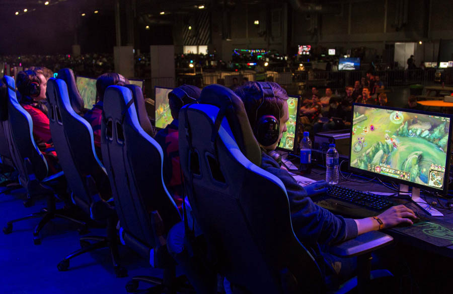 five male persons playing video games in a hall of Insomnia Egypt Gaming Festival 2025.