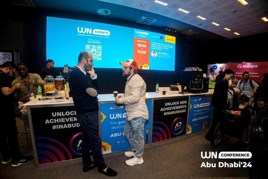 people talking to each other in a hall of WN Conference Abu Dhabi 2025.