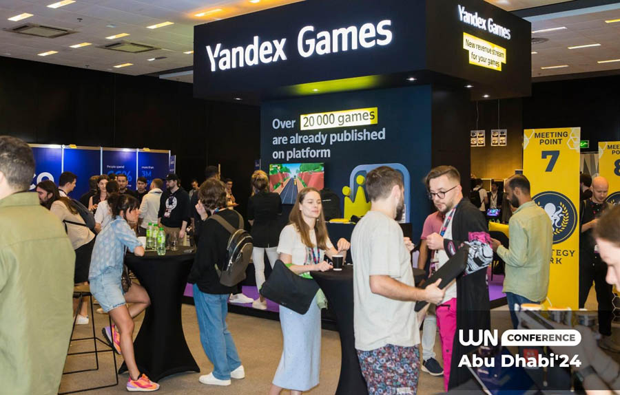 group of people passing over in a hall of WN Conference Abu Dhabi 2025.