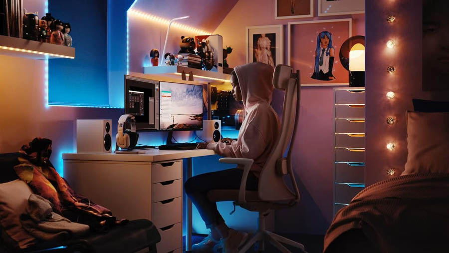 Image of a person sitting behind a desk and work setup.